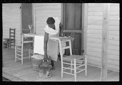 Housewife ironing, Caruthersville, Missouri, 1938