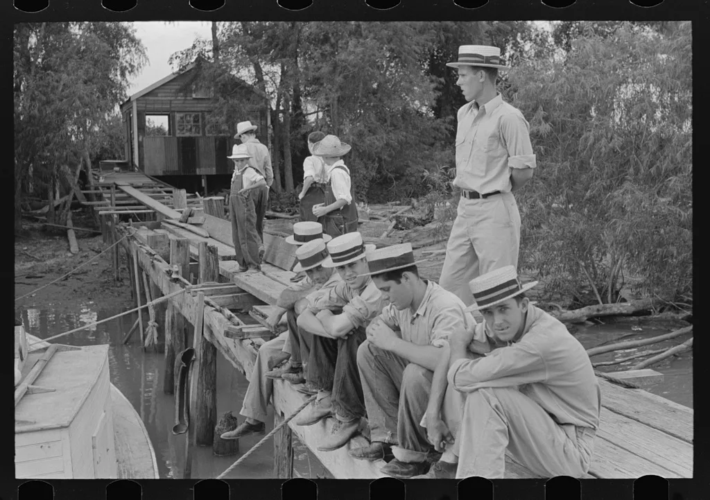 Residents at Boothville, Louisiana sitting on dock, 1938