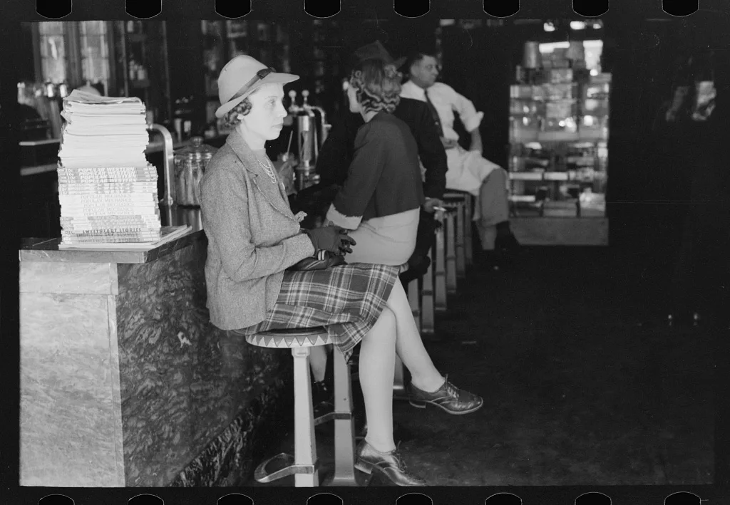 Woman sitting at soda fountain, Taylor, Texas, 1939