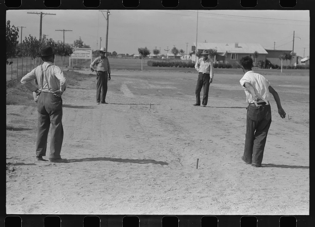 Pitching horseshoes at the Agua Fria Migratory Labor Camp, Arizona, 1940