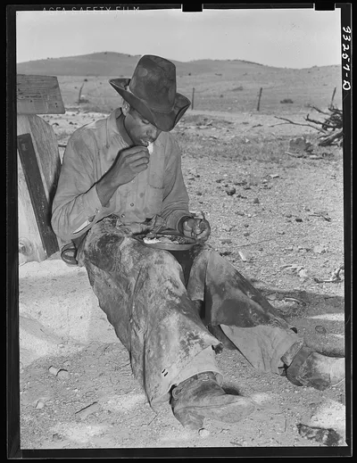 Mexican cowboy eating dinner after the roundup. Cattle ranch near…, 1939