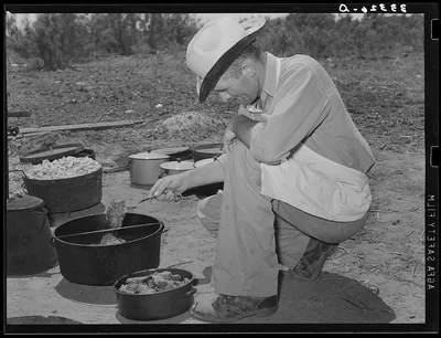 Cook of the SMS Ranch frying meat at chuck wagon on ranch near Spur,…, 1939