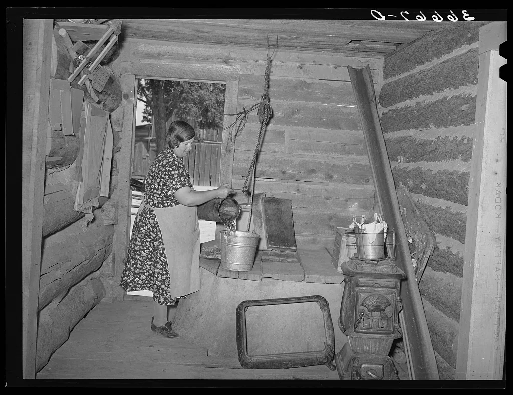 Mrs. Bill Stagg drawing water from her well, which is in enclosed…, New Mexico, 1940