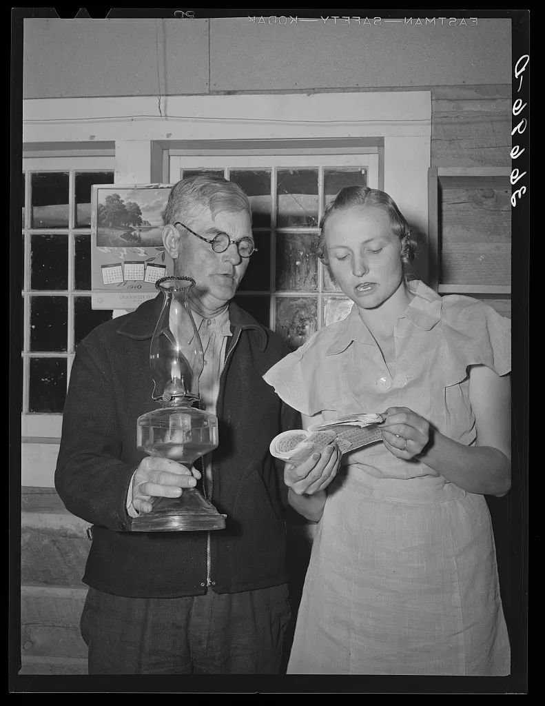 Mr. Besson, president of the literary society holds the lamp for Mrs.…, New Mexico, 1940