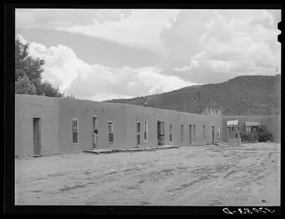 Row of adobe dwellings in Costilla, New Mexico. Well in square…, 1940