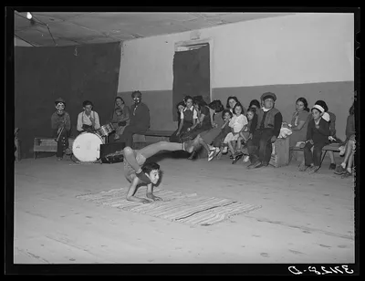 Acrobat and audience at Spanish-American traveling show. Penasco, New…, New Mexico, 1940