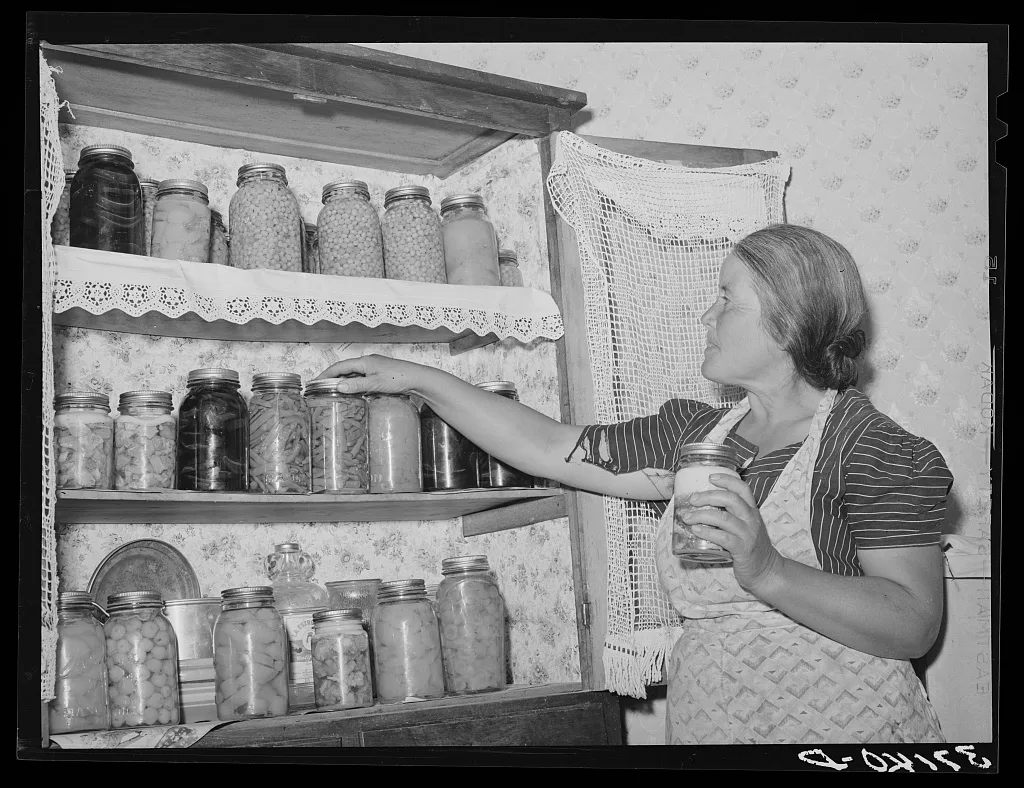 Wife of Spanish-American farmer with canned fruit and vegetables.…, New Mexico, 1940