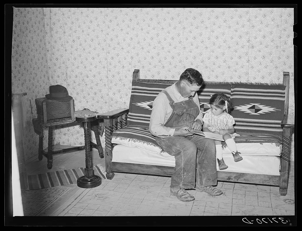Spanish-American farmer and his daughter seated on couch which his…, New Mexico, 1940