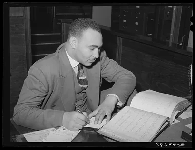 Employee in real estate office catering to Negro clients. Chicago,…, Illinois, 1941