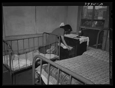 Young Mexican girl in corner of bedroom. San Diego, California, 1941
