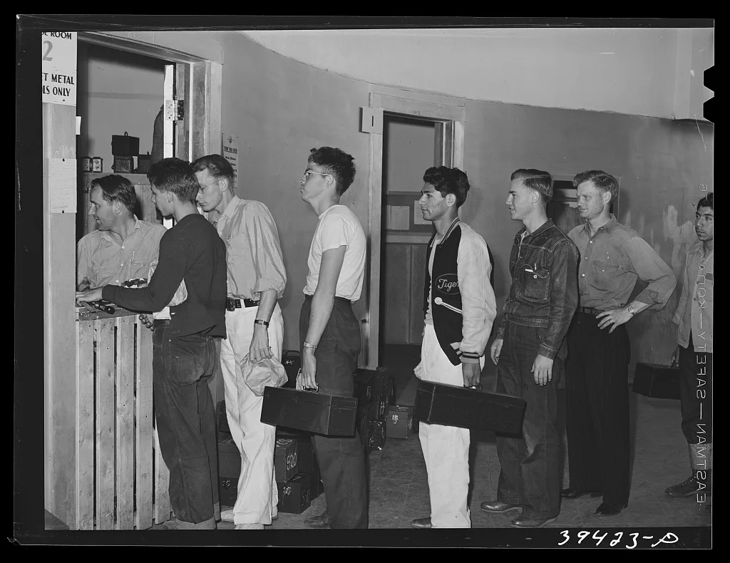 Checking in tools at the tool room at the vocational school for…, California, 1941