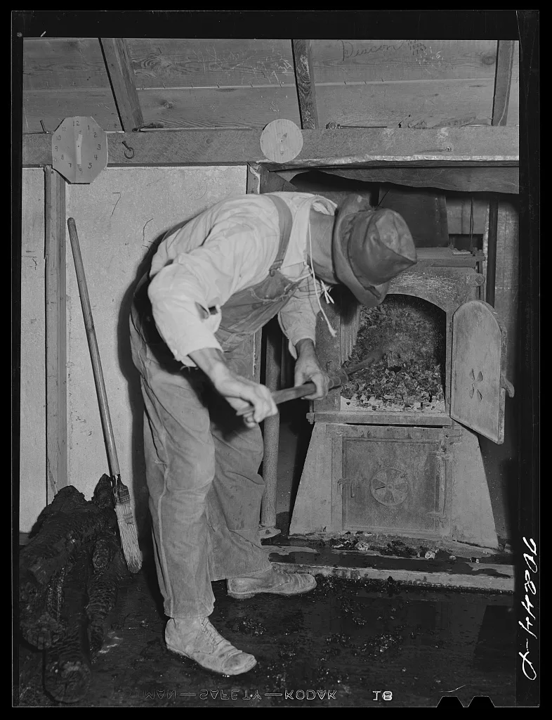Fixing the fire at hop kiln. Yakima County, Washington, 1941