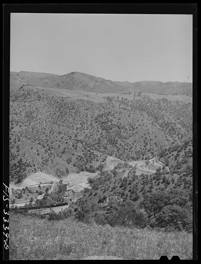 Kern County, California. Train going through a valley in the mountains, 1942